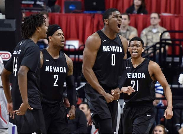 Nevada players, from left, Lindsey Drew, Tyron Criswell, Cameron Oliver and Eric Cooper Jr. cheer after Nevada took the lead in the final seconds of an NCAA college basketball game against New Mexico at the Mountain West Conference men&#039;s tournament Thursday, March 10, 2016, in Las Vegas. Nevada won 64-62. (AP Photo/David Becker)