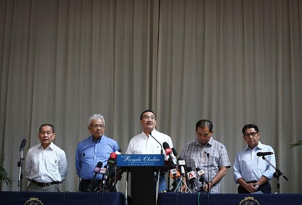 From left to right, Malaysia Airlines Group CEO Ahmad Jauhari Yahya, Deputy Minister of Foreign Affairs Hamzah Zainudin, Malaysia&#039;s acting Transport Minister Hishammuddin Hussein, third from left,  Deputy Minister, Abdul Aziz Kaprawi and Malaysian Department of Civil Aviation, Azharuddin Abdul Rahman attend a press conference for the missing Malaysia Airline, MH370 at a hotel in Kuala Lumpur, Malaysia, Saturday, April 19, 2014. An underwater robotic submarine is expected to finish searching a narrowed down area of the Indian Ocean seabed for the missing Malaysia Airlines plane within the next week, after completing six missions and so far coming up empty, the search coordination center said Saturday. (AP Photo/Vincent Thian)