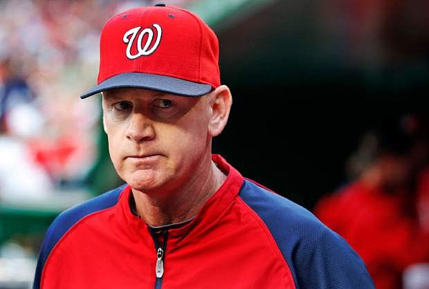 In this June 21, 2014, file photo, Washington Nationals manager Matt Williams walks in the dugout before the Nationals&#039; baseball game against the Atlanta Braves in Washington. Williams has been chosen NL Manager of the Year after guiding the Nationals to the league&#039;s best record in his first season on the job. Williams got 18 first-place votes and 109 points in balloting by the Baseball Writers&#039; Association of America announced Tuesday, Nov. 11. (AP Photo/Alex Brandon, File)