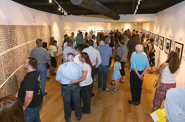 Always Lost: A Meditation on War program manager Amy Roby and Veterans Coordinator Kevin Burns speak at a final reception for the exhibit at Western Nevada College in Carson City, Nev., on Thursday, July 28, 2016. Program co-founder Marilee Swirczek, who died July 17, was also honored during the ceremony.