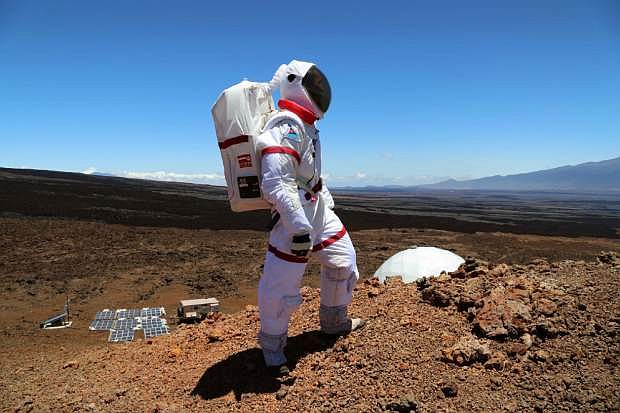 In this June 4 2013 photo provided by the University of Hawaii, research space scientist Oleg Abramov walks outside simulated Martian base at Mauna Loa, Hawaii. Six researchers have spent the past four months living in a small dome on a barren Hawaii lava field at 8,000 feet, trying to figure out what foods astronauts might eat on Mars and during deep-space missions. (AP Photo/University of Hawaii, Angelo Vermeulen)