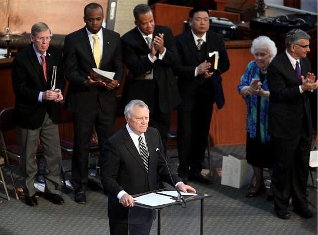 Gov. Nathan Deal, center, gets a standing ovation after his speech during the Rev. Martin Luther King Jr. holiday commemorative service at Ebenezer Baptist Church Monday, Jan. 20, 2014, in Atlanta. (AP Photo/Jason Getz)