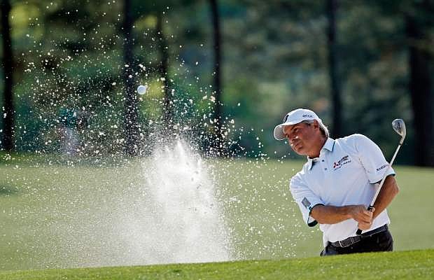 Fred Couples blasts out of a bunker on the 17th fairway during the second round of the Masters golf tournament Friday, April 11, 2014, in Augusta, Ga. (AP Photo/Matt Slocum)