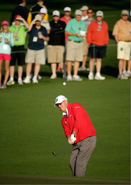 Sandy Lyle, of Scotland, chips to the second green during the second round of the Masters golf tournament Friday, April 11, 2014, in Augusta, Ga. (AP Photo/Chris Carlson)