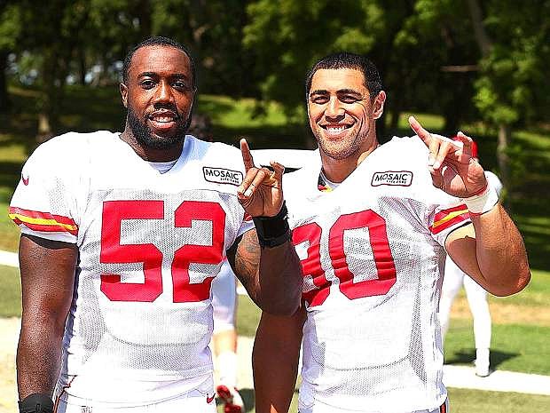 Former University of Nevada teammates James-Michael Johnson, left, and Josh Mauga salute their alma mater after practice with the Kansas City Chiefs last week.