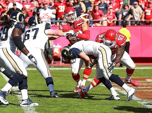 Chiefs linebacker Josh Mauga, back, fights off a block as defensive lineman Allen Bailey sacks St. Louis quarterback Austin Davis last week. Mauga faces his old team, the New York Jets, on Sunday.
