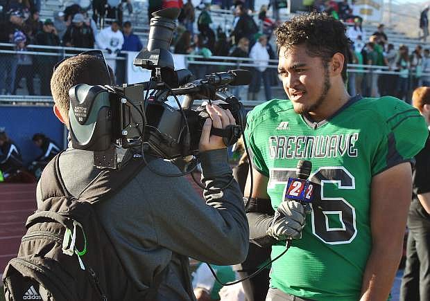 The Greenwave varsity football team&#039;s TJ Mauga (right) talks to broadcast reporters after the Wave&#039;s state championship victory in Reno.