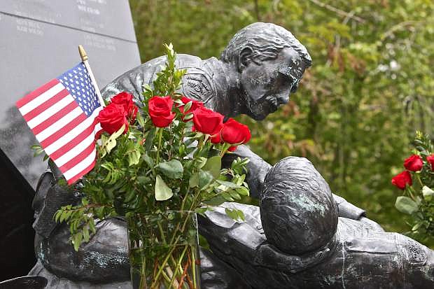 The Fallen Officers Memorial is adorned with flags and roses Thursday afternoon on the Capitol Mall.