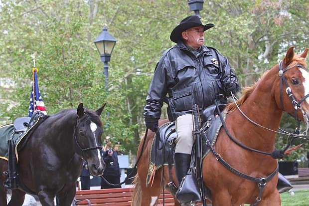 Joe Bruno, commander of the CCSO Mounted Unit, rides into the Captiol Mall with a riderless horse honoring fallen officers Thursday.
