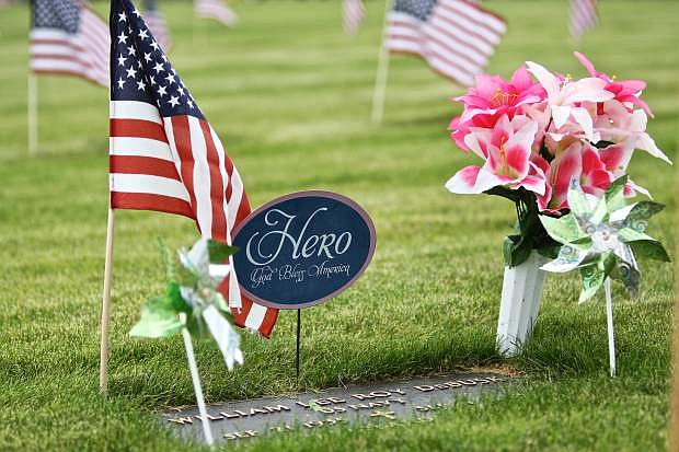 Navy veteran William Lee Roy DeBusk&#039;s resting place at Lone Mountain Cemetary is decorated for Memorial Day Friday.