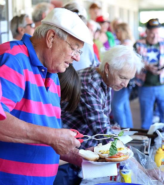 Carson City resident Tom Tomashek makes a plate of food at the annual free Memorial Day barbecue hosted by Evergreen Gene&#039;s on Monday.