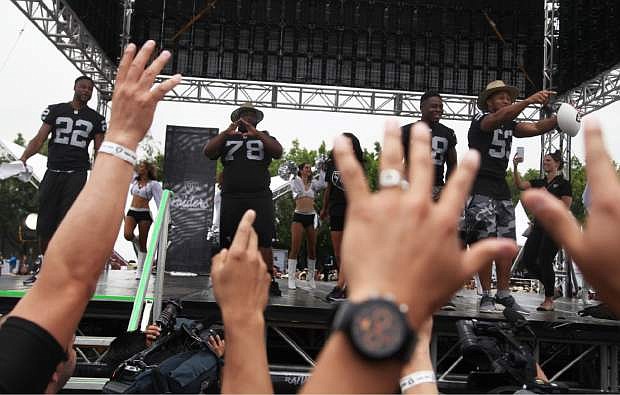 Oakland Raiders players, from left, Taiwan Jones (22), Justin Ellis (78), T.J. Carrie (38) and Malcolm Smith (53) dance before fans at Azteca Stadium where the team announced their third day NFL picks in Mexico City, Saturday, April 30, 2016. The Raiders will play the Houston Texans at Azteca on Nov. 21, 2016 during the NFL regular season. (AP Photo/Marco Ugarte)