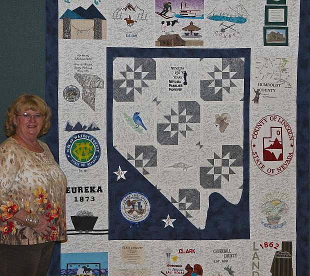 Linda Graeber poses with an unfinished Nevada Sequicentennial quilt at the Church of Christ of Latter-Day Saints in Carson City Wednesday.