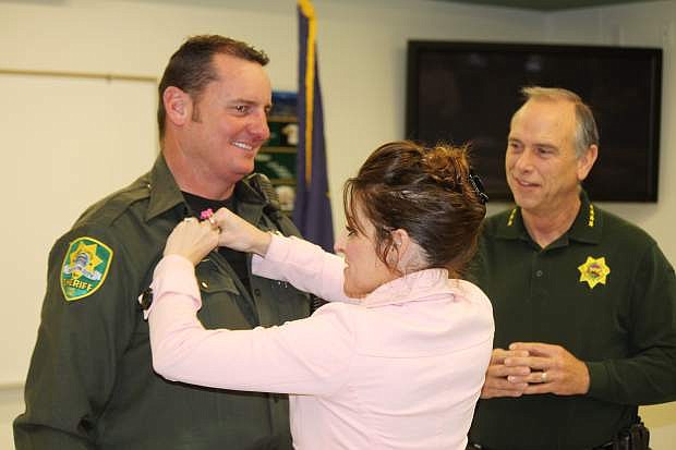 Deputy Wayne Wheeler gets his motor pin from his wife Sabrina Friday at the Carson City Sheriff&#039;s Office. Wheeler is the newest deputy assigned to the Motors Patrol Division for the department.
