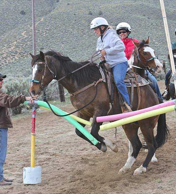 Washoe County Mounted Posse member Brenda Lung leads her horse through the &#039;courage test&#039; Thursday during training at Silver Saddle Ranch.