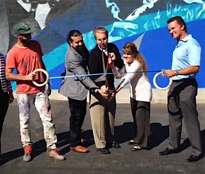 Reno artist Erik Burke, far left, joins Carson City Mayor Bob Crowell and other officials to cut the ribbon of the mural, including McDonald&#039;s owner Chris Kassity, far right.