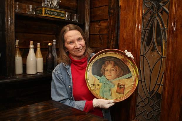 Laurie Hickey shows a platter on display at the CV Saloon, downstairs at the Carson Valley Museum &amp; Cultural Center.