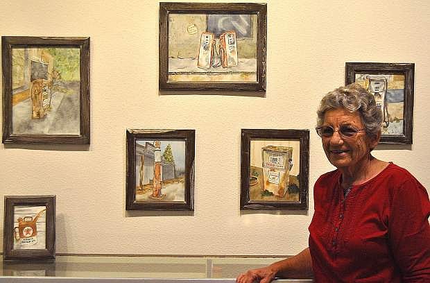 April Oakden stands in front of a few pieces from her exhibit at the Churchill County Museum.