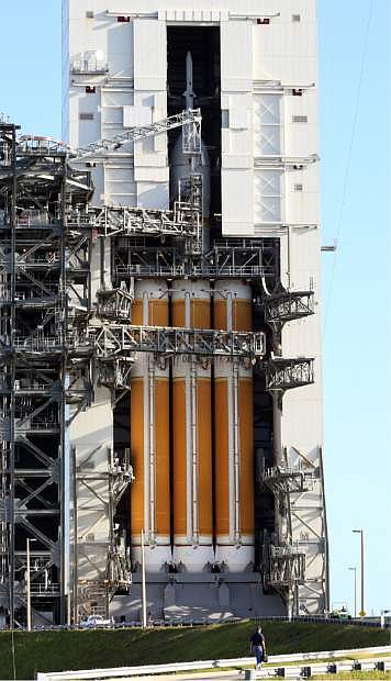 A worker walks up to the launch pad as final preparations are underway for Nasa&#039;s Orion flight test at complex 37 at the Cape Canaveral Air Force Station, Wednesday, Dec. 3, 2014 in Cape Canaveral, Fla. Orion is scheduled to lift off Thursday, Dec. 4, 2014, on a United Launch Alliance Delta 4-heavy rocket on its first unmanned orbital test flight. (AP Photo/Marta Lavandier)