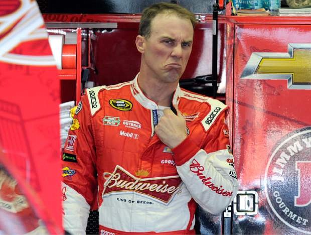 Kevin Harvick reacts as he talks to crew members during a NASCAR Sprint Cup series auto race practice at Darlington Speedway in Darlington, S.C., Friday, April 11, 2014. (AP Photo/Mike McCarn)