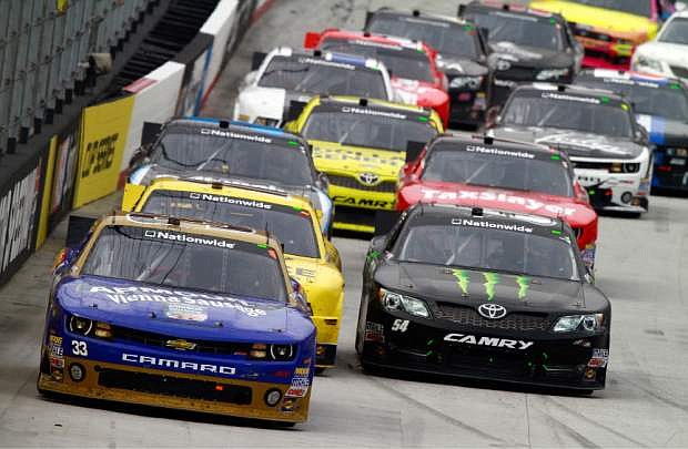 Kevin Harvick (33) leads Kyle Busch (54) and the rest of the field during the NASCAR Nationwide Series auto race Saturday, March 16, 2013, in Bristol, Tenn. Busch won the race. (AP Photo/Wade Payne)