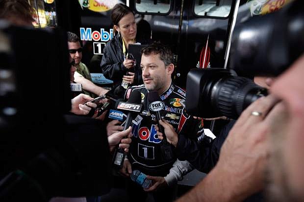 Driver Tony Stewart talks with the media during a break between practice sessions for Sunday&#039;s NASCAR Sprint Cup Series Pocono 400 auto race, Saturday, June 8, 2013, in Long Pond, Pa. (AP Photo/Matt Slocum)
