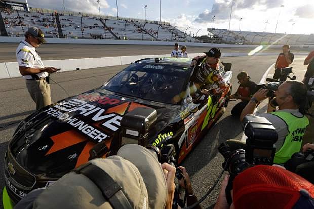 Jeff Gordon gets out of his car during qualifying at the Richmond International Raceway in Richmond, Va., Friday, Sept. 6, 2013. Gordon won the pole.  (AP Photo/Steve Helber)