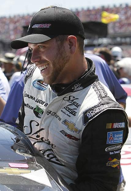 Driver Brian Scott (33) leaves his car after taking the pole during qualifying for the NASCAR Sprint Cup Series auto race at Talladega Superspeedway, Saturday, May 3, 2014, in Talladega, Ala. (AP Photo/Butch Dill)