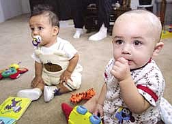 photo by Cathleen AllisonChristina Ortega, 7 months, left, and Dakota Pacheco, 8 months, play on Monday afternoon in North Casrson. Both boys had surgery to correct a craniosynostosis, a premature closure of the skull bones.