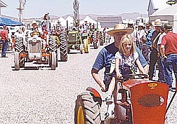 Brian Corley Amanda Nelson, 7, drives a tractor with her grandfather, Don Nelson, during the tractor show Saturday. The event continues today at the Johnson Lane home of Bill and Dorine Ramsden.