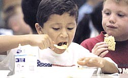 Eduardo Arreola, 7, enjoys his spaghetti during lunch at Mark Twain Elementary on Wednesday.  Elementary students throughout the Carson City School District returned to school this week.  Arreola says his favorite part of school is eating.
