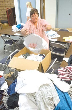 MaryEllen Radtke sorts underwear from one of nearly 50 boxes which were purchased wholesale from Kmart. Radtke, a Nevada Bell Pioneer, and is helping the school district&#039;s Children in Transition program, which provides clothing to disadvantaged students. Photo by Brian Corley