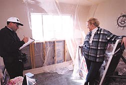 Mountain Park homeowner Jan-Marie Brown looks over destructive testing of her home in March.  Brown is one of 381 homeowners involved in a lawsuit against Stanton Park Development alleging multiple deficiencies in the construction of their homes.