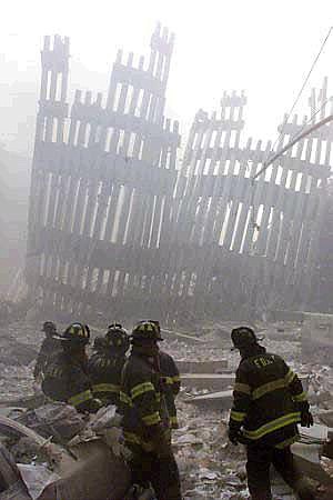Peter Morgan/ReutersFiremen work around the remains of the World Trade Center after two planes