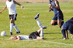 Amber Gwinn, of DHS, takes a fall after colliding with Allison Kop, of CHS, right, during Tuesday&#039;s game at Douglas.  photo by Rick Gunn