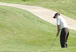 UNR Golfer Casey Watabu chips the ball at the 5th hole at Genoa Lakes Golf Course Tuesday afternoon.  photo by Rick Gunn