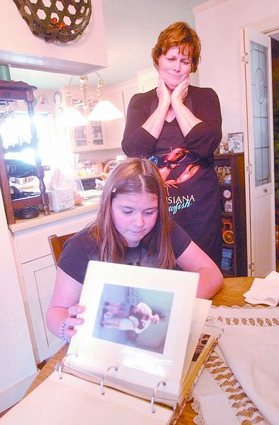 Judy Jacoboni and her granddaughter, Alyssa Alonso, 10, look at pictures of Michelle Jacoboni who was killed in 1990 by a drunk driver. The driver that hit her was released 5 months ago only to get another DUI at a blood alcohol level twice the legal limit and recieved one year of delayed prison time. Photo by Brian Corley