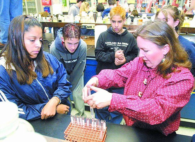 Cathleen AllisonCarson Middle School eighth-grade science teacher Mary Long, right, demonstrates an experiment for students, from left, Monica Gonzalez, Logan Merriwether, Eddie Martinez and Alyssa Johnson. The students were at Western Nevada Community College for a demonstration by Professor Steve Carman on Wednesday morning.