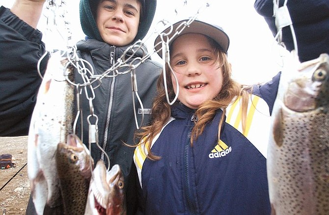 Left to right, Elijah Townsend, 13, and Moriah Lane, 8, show off their catch near the shore of Topaz Lake Tuesday morning during opening day.   The two hooked 5 Rainbow Trout. photo by Rick Gunn