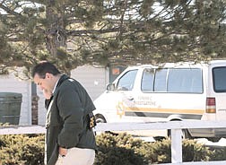 Carson City detective Jim Primka talks on a phone after a search of the home of Sami Donovan. Donovan was accused of several felony charges for selling property thousands of dollars which didn&#039;t belong to her over internet auction sites. Photo by Brian Corley
