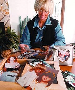 Photo by Bill HusaGayle Farley sobs quietly at her home in Carson City while going through family photos of her daughter Kellie Parry who was killed October 1999.