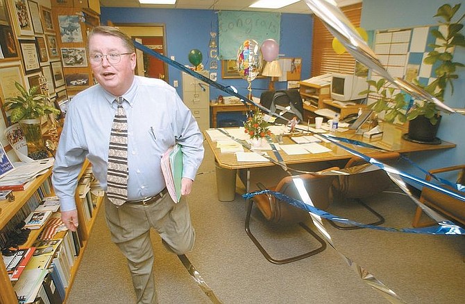 CHS principal Glenn Adair steps over a ribbon which lined his office after students decorated it Tuesday. The students and faculty of the high school were congratulating adair for completing his last chemotherapy session seemingly overcoming his recent battle with cancer. photo by rick Gunn