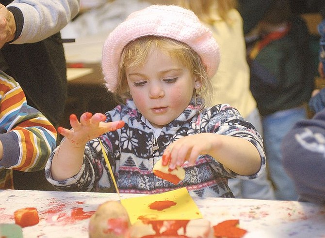 Hannah Eckert, 3, stamps a Valentine with a paint-soaked sponge. Eckert along with others made Valentine Cards with their mothers in an effort to get one to each shut-in in the Carson, Douglas  and Washoe Counties. Carson City needed about 1,000 cards to satisfy its need. Photo by Brian Corley