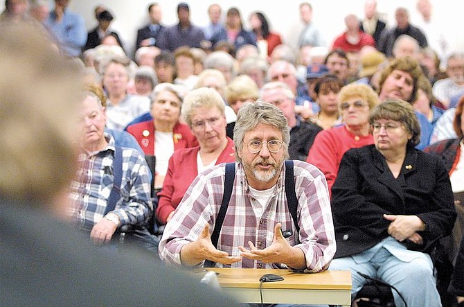 Charles Martins, center, questions the Public Utilities Commission of Nevada on Monday night during a consumer session in Carson City.  A capacity crowd of mostly disgruntled energy customers filed in to protest a proposed rate hike.