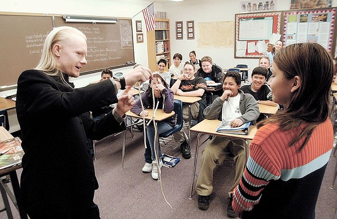 International illusionist and former Eagle Vallely Middle School student Eli Kerr performs a rope trick with the EVMS student and impromptu assistant Alejandra Hernandez, 14 during career day at the middle school Tuesday afternoon.  photo by Rick Gunn