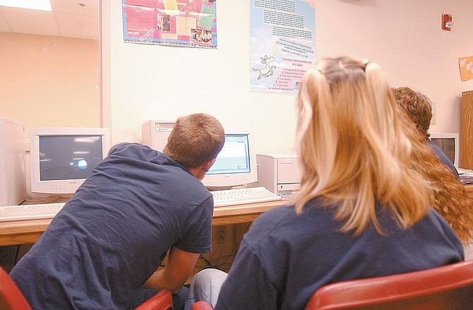 Several unidentified kids sit in front of a computer at the Western Nevada Regional Youth Center. The center helps treat youths with drug and alcohol related problems, including computer training. Photo by Brian Corley