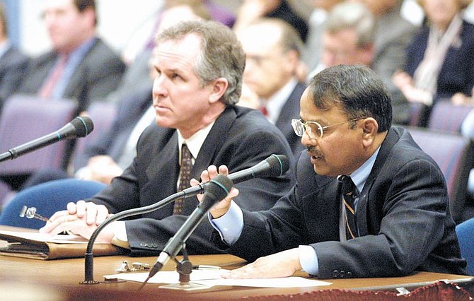 Dr. Raj Chanderraj, right, representative for the Clark County Medical Society, speaks at the Medical Malpractice Hearing at the Legislative Building in Carson City on Monday morning.  Dr. Daniel McBride, a Las Vegas surgeon, left, also spoke to the committee.