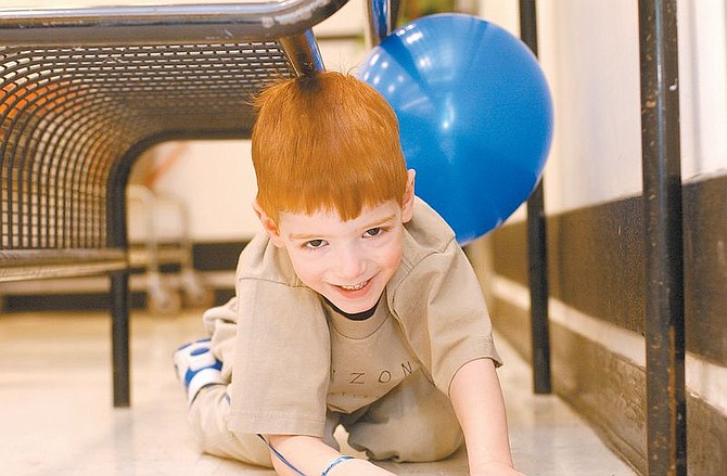 Rick GunnNathan Davis, 4, crawls under a bench on Thursday morning at the Carson City Super Kmart. Nathan, one of two March of Dimes Ambassador children, was helping kickoff this year&#039;s WalkAmerica Campaign. Born 2-months premature, Nathan has grown into an active, healthy boy.