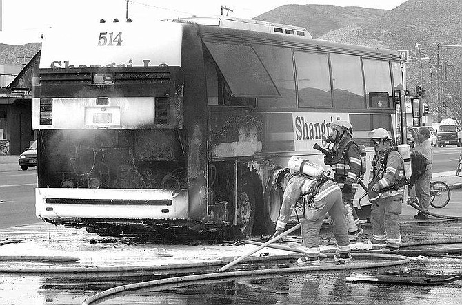 Rick Gunn photoFirefighters were called when a tour bus caught fire in front of Grocery Outlet on North Carson Street on Wednesday afternoon. The flames from the engine engulfed the bus.