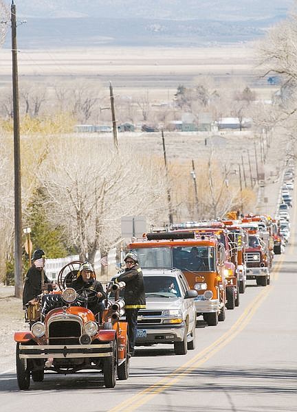 A funeral procession for Douglas County Engine Company&#039;s Dan Hellwinkel proceeds towards Genoa on Genoa Lane Saturday afternon on route from St. Gall Catholic Church in Minden.  photo by Rick Gunn
